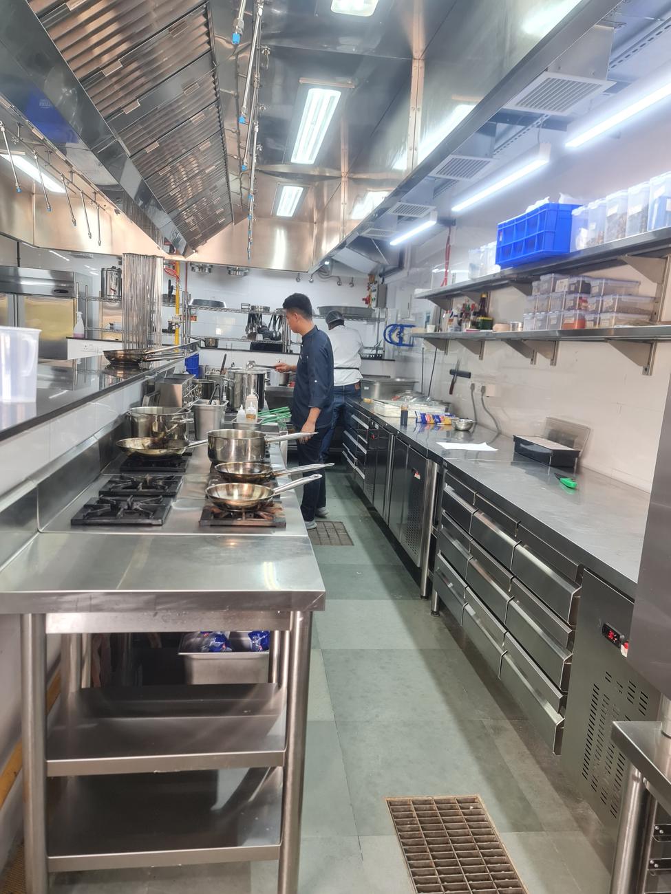 Stainless steel cooking line in a commercial kitchen